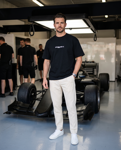 PEAK Heavy Tee in Black worn in a race team pit garage