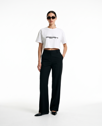 Woman wearing the PEAK Women's Crop Tee in White